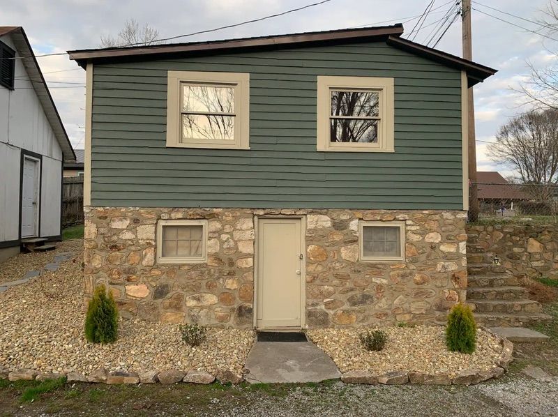 Cottage Two exterior with stone foundation and covered porch